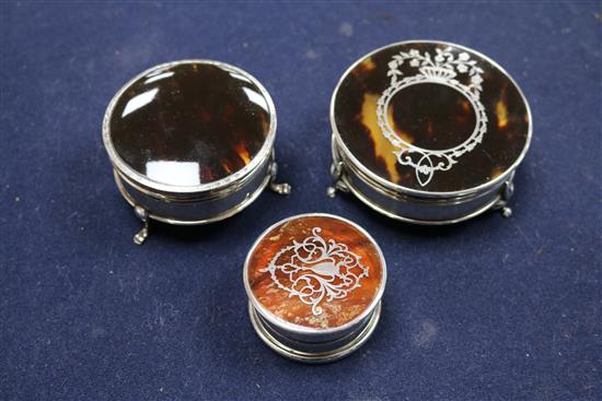 Three circular silver and tortoiseshell trinket boxes, two with pique decoration,